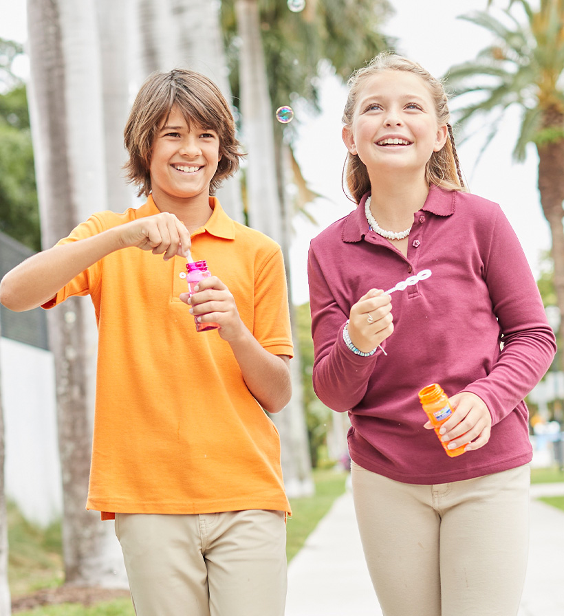 boy wearing short sleeve polo and girl wearing long sleeve polo