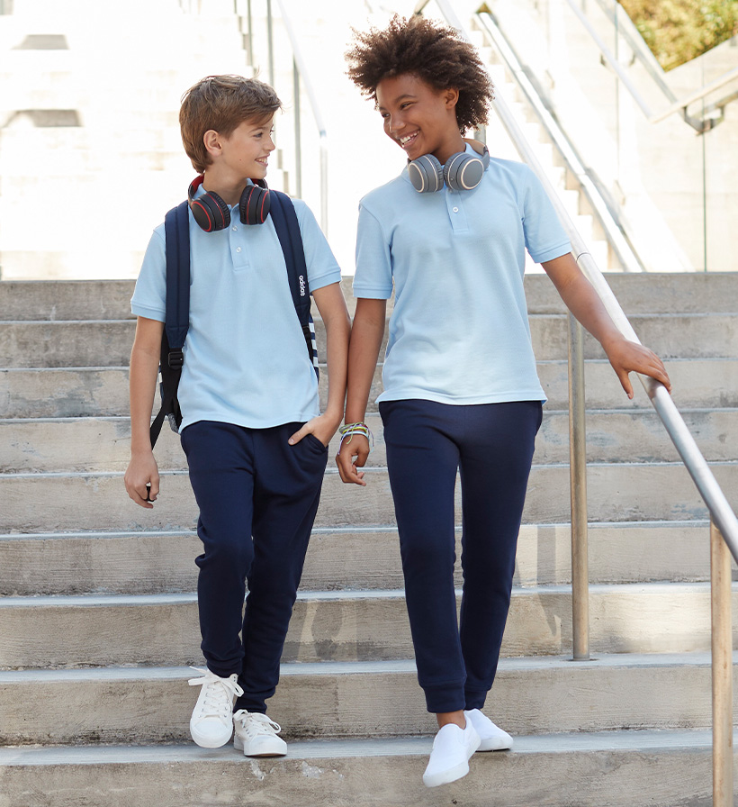 boy and girl in matching blue polos and navy khakis